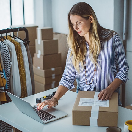 a woman sitting at a table in front of a box